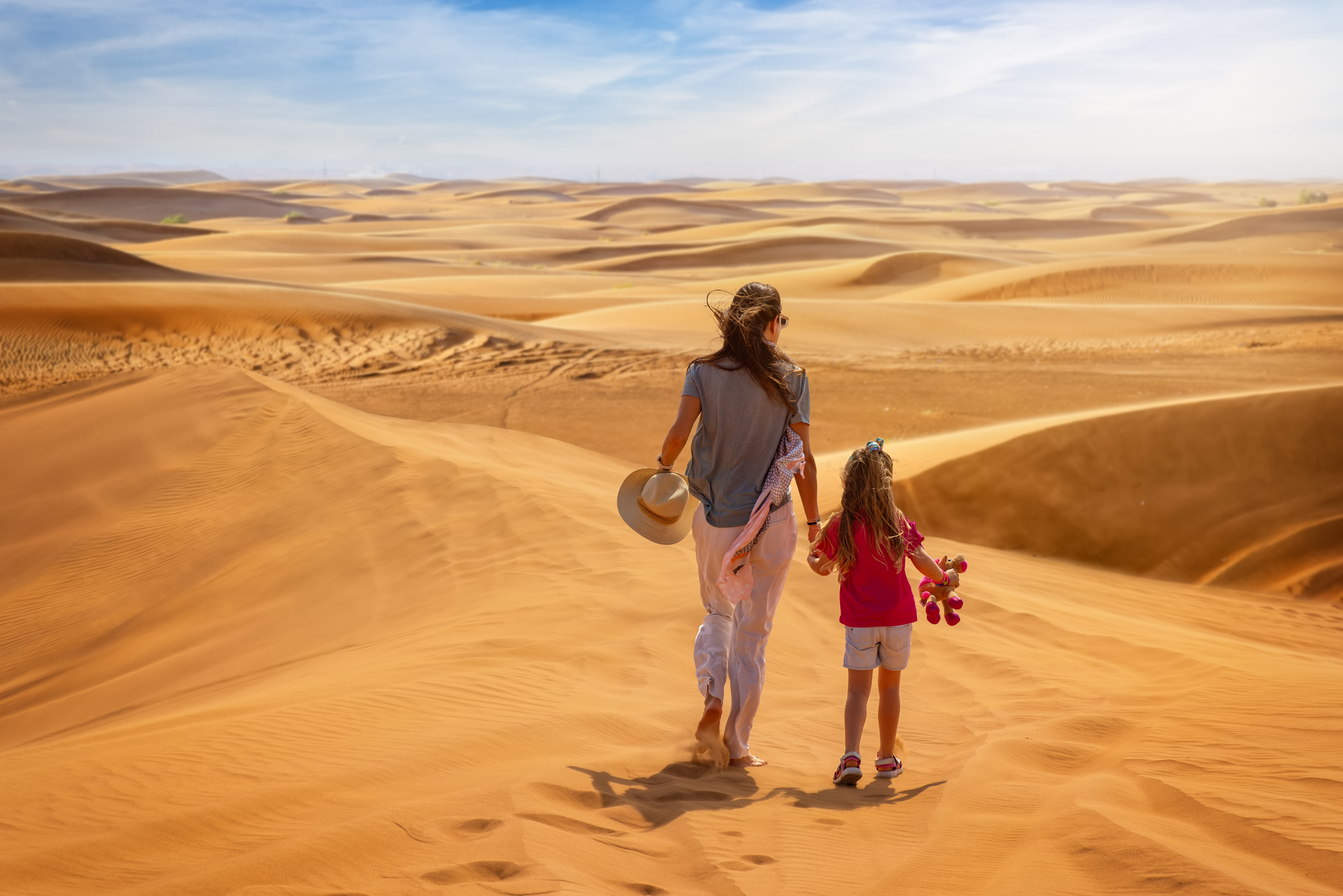 A mother and daughter exploring the desert near Dubai